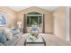 Sunlit living room with vaulted ceilings, a large window and neutral tones throughout at 10152 Telluride St, Littleton, CO 80125