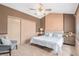 Cozy carpeted bedroom features a ceiling fan, decorative wall trim, and a closet at 10152 Telluride St, Littleton, CO 80125