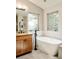 Clean bathroom featuring modern tub, sleek fixtures, and vanity with granite countertops at 2253 Augusta Dr, Evergreen, CO 80439