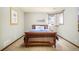 Bedroom featuring a wood frame bed, plush bedding, and serene natural light at 2253 Augusta Dr, Evergreen, CO 80439