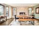 Dining area featuring hardwood floors, a stone accent wall with fireplace, and views to the outside at 2253 Augusta Dr, Evergreen, CO 80439