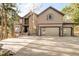 Charming two-story home with a three car garage and large driveway surrounded by mature trees at 2253 Augusta Dr, Evergreen, CO 80439