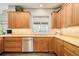 Kitchen with wooden cabinets, tile backsplash, stainless dishwasher, and plenty of counter space at 2253 Augusta Dr, Evergreen, CO 80439