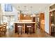 Open kitchen featuring light wood cabinets, pendant lighting, and breakfast bar at 2253 Augusta Dr, Evergreen, CO 80439