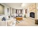 Inviting living room with stone fireplace, plush seating, and great natural light at 2253 Augusta Dr, Evergreen, CO 80439