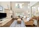 Bright living room with a stone fireplace, large windows, and comfortable seating arrangement at 2253 Augusta Dr, Evergreen, CO 80439