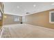 Finished basement with carpet, recessed lights, wet bar, projector and three shuttered windows at 570 Stonemont Dr, Castle Pines, CO 80108