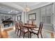Dining room table set for six with a view into the living room piano and many windows at 570 Stonemont Dr, Castle Pines, CO 80108