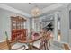 Dining room features a china cabinet and oval table that seats six, with view to living room at 570 Stonemont Dr, Castle Pines, CO 80108