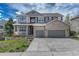 Attractive two-story home featuring brick and siding accents, a two-car garage, and a landscaped front yard at 570 Stonemont Dr, Castle Pines, CO 80108