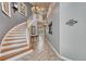 Grand foyer showcasing a curved staircase, tile flooring, elegant decor, and a view into other living spaces at 570 Stonemont Dr, Castle Pines, CO 80108