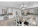 Open kitchen and dining area offer stainless appliances, island counter, and seating at 570 Stonemont Dr, Castle Pines, CO 80108