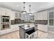 Bright kitchen with stainless appliances, island counter, and dark granite countertops at 570 Stonemont Dr, Castle Pines, CO 80108