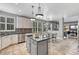 Open kitchen features stainless appliances, island counter, and great natural light from shuttered windows at 570 Stonemont Dr, Castle Pines, CO 80108