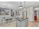 Kitchen and dining area offer black granite island, stainless fridge, and plenty of cabinetry at 570 Stonemont Dr, Castle Pines, CO 80108
