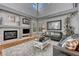 Inviting living room showcases a cozy fireplace, ample natural light, and chic design at 570 Stonemont Dr, Castle Pines, CO 80108