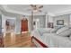 The main bedroom boasts hardwood floors, a four poster bed, a ceiling fan, and an ensuite bathroom at 570 Stonemont Dr, Castle Pines, CO 80108