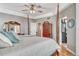 Well lit primary bedroom features a four poster bed, hardwood floors and access to the bathroom at 570 Stonemont Dr, Castle Pines, CO 80108
