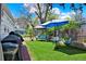 A well-maintained backyard features artificial grass, a swing set, a gazebo and an outdoor dining area at 5211 Dover St, Arvada, CO 80002