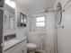 Clean bathroom featuring a walk-in tub, a functional sink, and ample lighting at 5211 Dover St, Arvada, CO 80002
