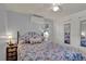 Comfortable bedroom with a floral patterned bedspread and a mirrored closet at 5211 Dover St, Arvada, CO 80002