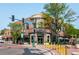A HomeGrown Tap & Dough corner brick building features outdoor seating, green trim, and street-side trees at 5211 Dover St, Arvada, CO 80002