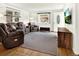 Cozy living room with plush seating, lots of natural light, and hardwood floors at 5211 Dover St, Arvada, CO 80002