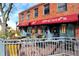 Charming outdoor patio with flower pots, iron railings, and a brick building backdrop at 5211 Dover St, Arvada, CO 80002
