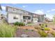 Landscaped backyard featuring a well-maintained lawn, a patio, and vibrant landscaping at 8582 Cheraw St, Littleton, CO 80125