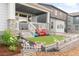 Charming covered porch with a small artificial lawn and lovely garden and landscaping at 8582 Cheraw St, Littleton, CO 80125