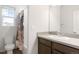 Well-lit bathroom includes a shower/tub combination and a stylish vanity at 8582 Cheraw St, Littleton, CO 80125