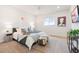 Bright bedroom with plush carpeting, a large bed, and a TV, perfect for relaxation at 8582 Cheraw St, Littleton, CO 80125