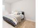 Bright bedroom featuring a bed with stylish striped bedding and a fur rug at 8582 Cheraw St, Littleton, CO 80125