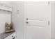 Functional entryway with bench, coat hooks, and storage, creating an organized welcome at 8582 Cheraw St, Littleton, CO 80125