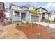 Beautiful two-story home features a manicured front yard with a cozy porch and a two-car garage at 8582 Cheraw St, Littleton, CO 80125