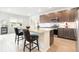 Modern kitchen with stainless steel appliances, granite countertops, and a breakfast bar with seating for two at 8582 Cheraw St, Littleton, CO 80125