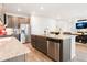 Open-concept kitchen with stainless steel appliances, granite countertops, and an island that opens to the living area at 8582 Cheraw St, Littleton, CO 80125