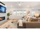 Bright living room features a fireplace, plush sectional couch, and large windows for natural light at 8582 Cheraw St, Littleton, CO 80125