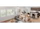 Open-concept living area with a sectional couch, dining table and a kitchen with granite countertops at 8582 Cheraw St, Littleton, CO 80125