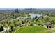 Aerial view of Denver's City Park, featuring lakes, walking paths, and the Denver skyline at 1622 Monroe St, Denver, CO 80206