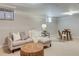Finished basement with neutral tones, plush carpeting, sofa, and inviting lighting at 1622 Monroe St, Denver, CO 80206