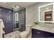 Updated bathroom featuring navy blue subway tile shower, marble accent wall, and modern vanity at 1622 Monroe St, Denver, CO 80206