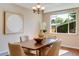 Dining room with a chandelier, bright window, and seating for four people at 1622 Monroe St, Denver, CO 80206