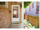 View of the front door, and covered porch with hanging plants, offering a glimpse into a welcoming home at 1622 Monroe St, Denver, CO 80206