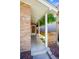 Covered front porch with hanging ferns, providing a welcoming entrance and added privacy at 1622 Monroe St, Denver, CO 80206