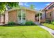 Charming brick home featuring a lush lawn and well-maintained landscaping, creating excellent curb appeal at 1622 Monroe St, Denver, CO 80206