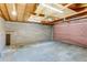 The interior of this two-car garage has cement walls, a concrete floor, and an automatic garage door opener at 1622 Monroe St, Denver, CO 80206