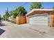 The exterior of this home has a brick, two-car garage with a white garage door in a private alley at 1622 Monroe St, Denver, CO 80206