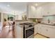 Modern kitchen with granite countertops, white cabinets, stainless steel appliances, next to dining area at 1622 Monroe St, Denver, CO 80206