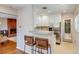 Modern kitchen with granite countertops, white cabinets, stainless steel appliances, and breakfast bar seating at 1622 Monroe St, Denver, CO 80206